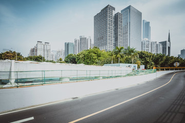 empty road with zebra crossing and skyscrapers in modern city