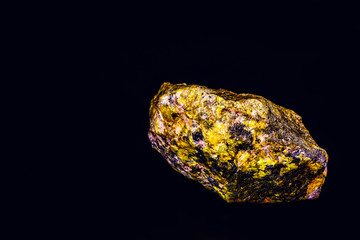 uranium mineral isolated on black background. Highly radioactive and dangerous ore. © RHJ