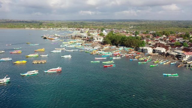 Aerial, rising, drone shot towards the Tanjung Luar Fish Market, on a sunny day, in Lombok, West Nusa Tenggara, Indonesia