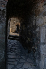 View through an arched passage in a thick rampart
