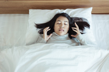 Bad dream or Nightmare,Asian woman with scared and panic while lying down under the blanket in...