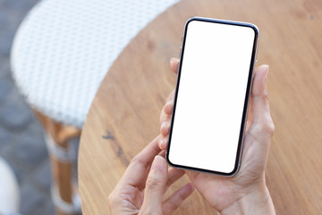 Mockup image blank white screen cell phone.men hand holding texting using mobile on desk at home office.background empty space for advertise text.people contact marketing business and technology