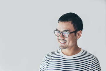 portrait young asian man wear eye glasses Smiling cheerful look thinking position with perfect clean skin posing on white background.fashion people freedom life style concept