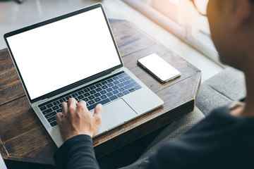 mockup image blank screen computer,cell phone with white background for advertising text,hand man using laptop texting mobile contact business search information on desk in office.marketing,design