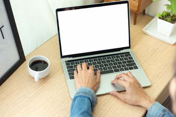 mockup image blank screen computer with blank white background for advertising text,hand man using laptop contact business search information on desk at home office.marketing and creative design