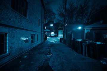 Dark and eerie urban city alley at night 