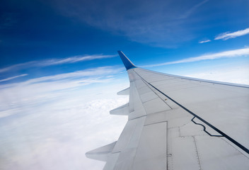 Fototapeta na wymiar Clouds and sky as seen through window of an aircraft