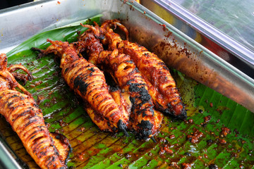 A picture of grilled squid in the tray for tea time. It is spicy and taste authentic.