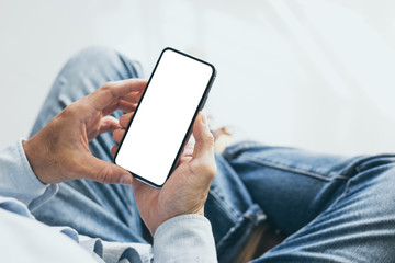 Mockup image blank white screen cell phone.man hand holding texting using mobile at home office.background empty space for advertise text.people contact marketing business,technology