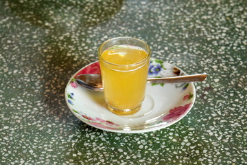 Small honey lemon tea on the table with natural light.