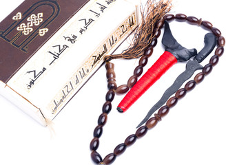 A picture of The Koran, keris and prayer beads as Malay always related to Muslim. The arab word mention in the picture is "the verse in the book never been authored and no lies".