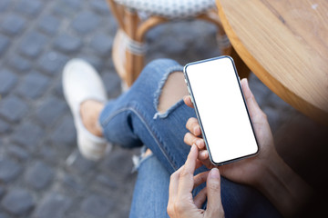 Mockup image blank white screen cell phone.man hand holding texting using mobile on desk at outdoor cafe.background empty space for advertise text.people contact marketing business,technology