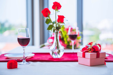 Romantic still life with pink champagne and beautiful red roses. Valentine's day concept. Soft focus