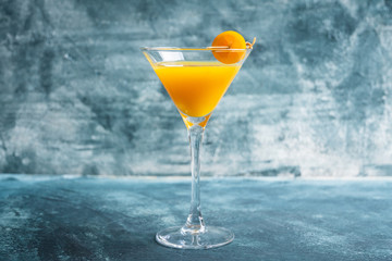 Sweet cocktail with kumquats on rustic background. Selective focus. Shallow depth of field.