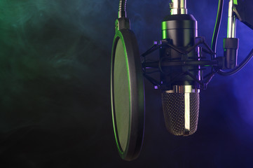 close-up. Studio condenser microphone Radio, vocals, colored smoke podcasts. Copy space.