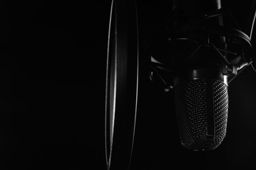 Close-up, Professional microphone in a recording studio. Black and white photo. Black background