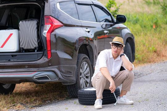 Asian man wait for support from technicien for change new tire