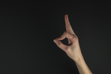 Zen symbol with fingers on a black background