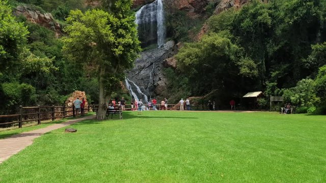 Families enjoying a picnic and photos near waterfall at the walter sisulu national botanical gardens in roodepoort, South Africa.