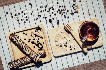 healthy eating and traditional bakery concept; fresh bread on the kitchen table with beverage at morning	