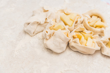 Woman making apple buns on the home kitchen. Selective focus. Shallow depth of field.