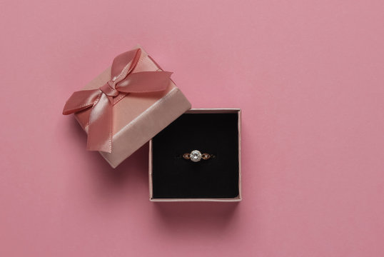 Gift Box And Engagement Gold Ring With Diamond On Pink Pastel Background. Wedding, Romantic Concept. Jewelry. Top View. Flat Lay