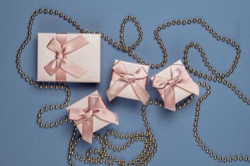 Gift boxes, garlands on purple background. Christmas concept. Top view