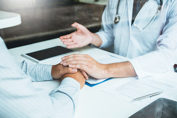 Doctor holding hands for comforting and care patient