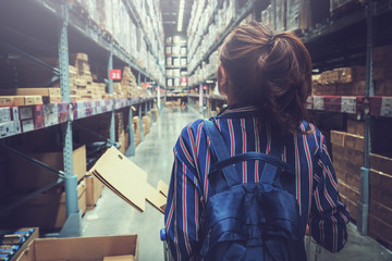 pretty woman walking on shopping and choosing in furniture store for her apartment