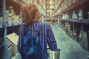Obraz premium pretty woman walking on shopping and choosing in furniture store for her apartment
