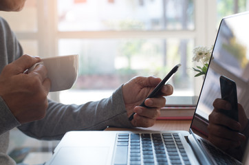Man working using smart phone and laptop computer