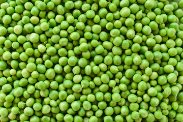 Green peas, peeled of tricks. Background. Vegetarianism.