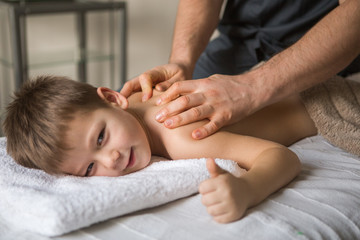Fototapeta na wymiar little boy receiving a massage