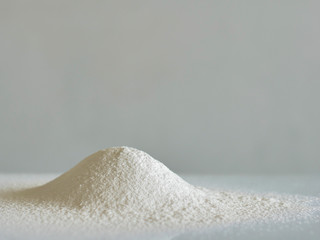 White flour on glass background. Spilled flour.