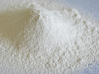 White flour on glass background. Spilled flour.