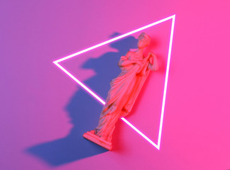 Antique goddess figurine. 80's synth wave and retrowave glowing triangle futuristic aesthetics. Old fashioned abstraction concept