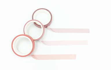 Close up top view of paper masking tape in set of pink arranging in a row and taping on board. Isolated on white background with copy space.