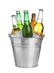 Beer in metal bucket with ice isolated on white