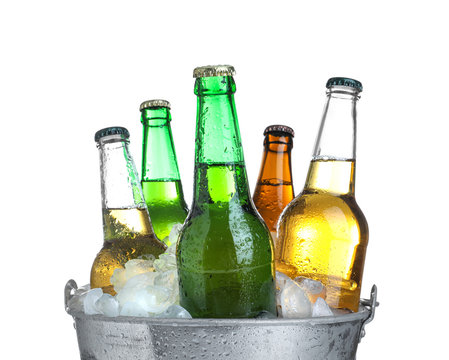 Beer in metal bucket with ice isolated on white