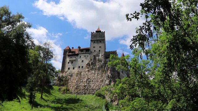 Cinematic wide angle view with sliding pan of the Bran Castle in Romania