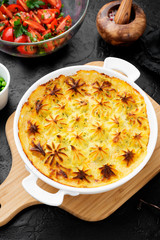 Fish pie with salmon, mashed potatoes, green peas and creamy sauce.