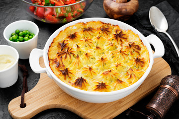 Fish pie with salmon, mashed potatoes, green peas and creamy sauce.