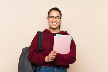 Fototapeta premium Young student Asian girl woman over isolated background applauding