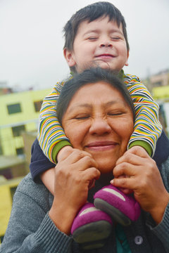 Tender portrait of indigenous South American woman with her little son.