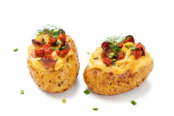 Hot baked potato topped with bacon, green onions and sun dried tomatoes. isolated on white background