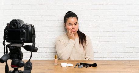 Young blogger Asian girl recording a video tutorial unhappy and frustrated