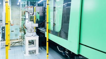 Smart factory industry 4.0 concept from robotic arm machine tool for production line of injection molding process at vehicle industrial factory.