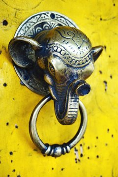 Vintage Brass Elephant Door Knocker On Bright Yellow Door