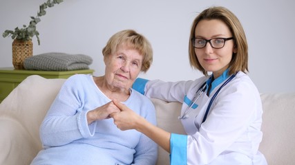 Portrait Of Smiling Doctor With Senior Patient. Medicine And Elderly Care.