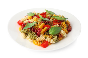 Colorful pasta with basil and cherry tomatoes isolated on white